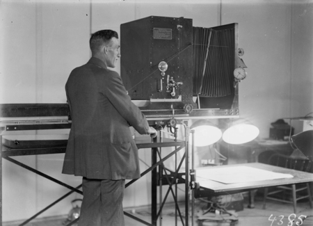 Photographic studio with large plan camera and operator.