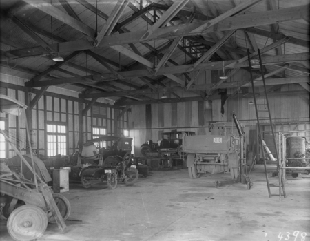 Interior of a garage showing cars, truck and a motor cycle at Kingston Depot.