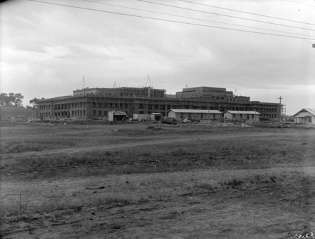 Parliament House under construction, frontage from north east. Brickworks railway in foreground.
