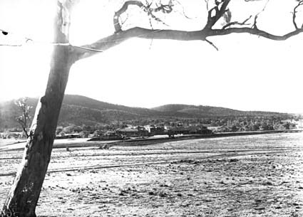 Hotel Canberra from the site of Parliament House with brickworks railway crossing Commonwealth Avenue after a snow fall