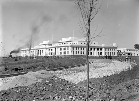 Parliament House from west side of Parkes place with steam shovel contructing King George Terrace.