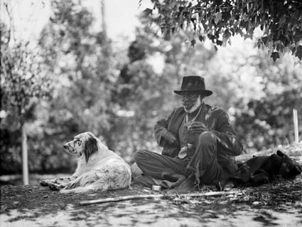 Aboriginal man [John Noble aka 'Marvellous'] and dog at Bachelors Quarters