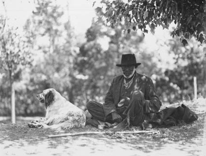 Aboriginal man [John Noble aka 'Marvellous'] and dog at Bachelors Quarters