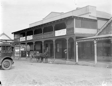 Hotel Walshes, Monaro St Queanbeyan with bakers delivery cart.