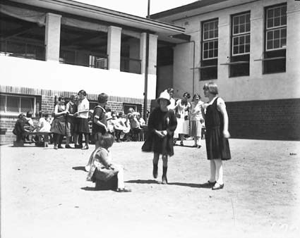 Rear of Telopea Park School with girls playing hopscotch
