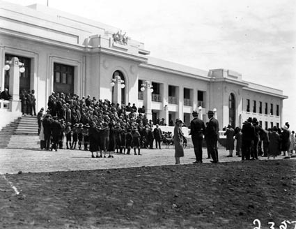 Group of Empire Parliamentary Association delegates in front of Parliament House. Canberra Boy Scouts providing the Guard of Honour