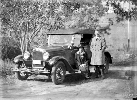 Mrs W J Mildenhall and Mr Ivo Smith in driveway of house in Acton