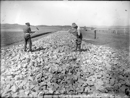 Road workers breaking rocks on Limestone Avenue