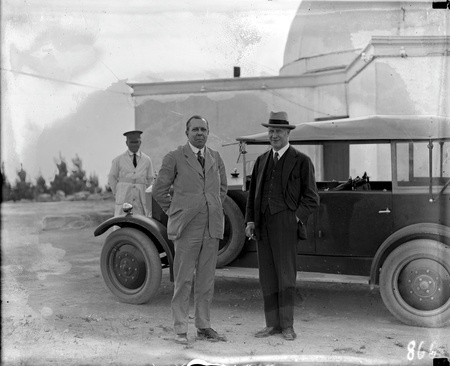 Commonwealth car and driver with two visitors at Mt Stromlo