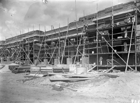 Scaffolding, workmen, concrete mixer and wheelbarrow, Parliament House.