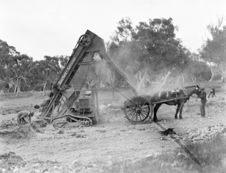 Barber Greene Ditch Digger loading drays.