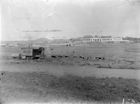 Steam shovel loading skips in front of Parliament House.