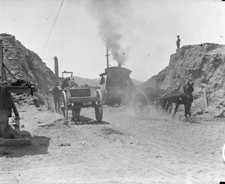 Keystone steam excavator at work on embankment of Commonwealth Avenue Bridge with horse drawn drays.