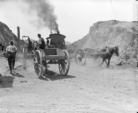 Keystone steam excavator at work on embankment of Commonwealth Avenue Bridge with horse drawn drays.