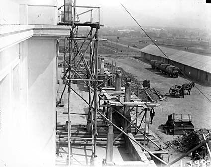 View from roof of Parliament House showing front facade, construction buildings and brickworks railway