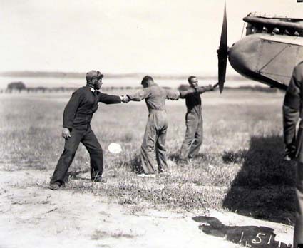 Winding propeller to start the engine of De Havilland DH9 aeroplane