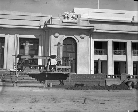 Parliament House main entrance with the Commonwealth Coat of Arms on the right.