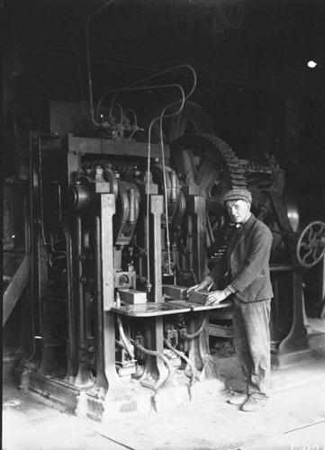 Brick pressing machine with operator at the Yarralumla  brickworks