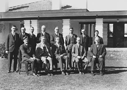 Presentation of Charter of Rotary Club, group photo [Sir Robert Garran, Sir John Butters and CS Daley can be identified] in front of Hotel Canberra