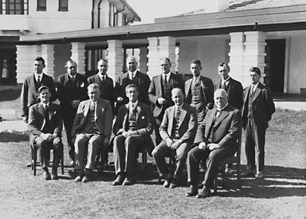 Presentation of Charter of Rotary Club, group photo [Sir Robert Garran, Sir John Butters and CS Daley can be identified] in front of Hotel Canberra