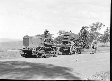 Cletrac crawler tractor towing a road grader. Note: boxes for COR fuel cans on the grader.