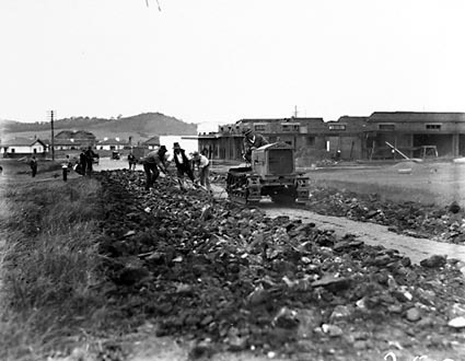 Cletrac crawler tractor pulling plough for road making near Kingston shops