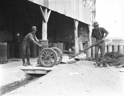 Workman making concrete pipes at Kingston