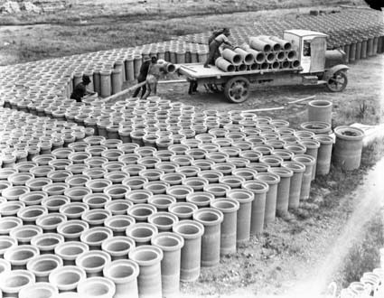 Concrete pipes being loaded on a motor truck at Kingston yards
