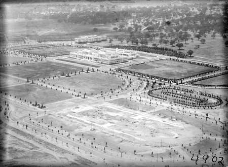 Aerial view over Parliament House and East Block with foundations for Treasury building in foreground.