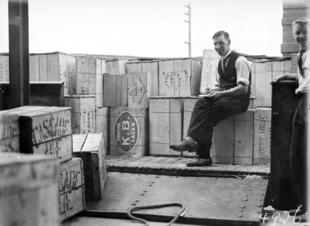 Legislation. First consignment of liquor following the lifting of Prohibition in the Federal Capital Territory. Railway truck load of beer cases with a tally clerk.