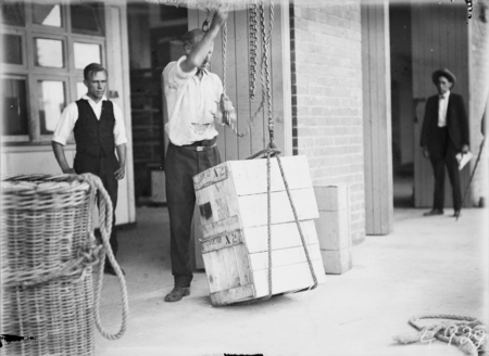 First consignment of liquor following the lifting of Probition in the ACT. Two cases of Sheaf Stout being lifted into storage.