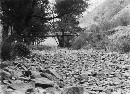 Cotter River below the Cotter Dam wall and the footbridge over the river. Low water flows in drought.