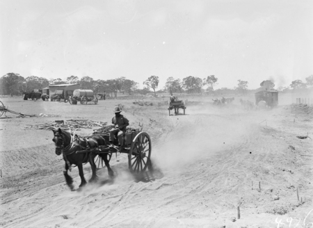 Horse drawn drays carrying spoil from War Memorial site.