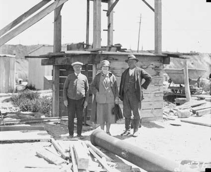 Two men and one woman near sewerage excavation - Jerry Dillon on right
