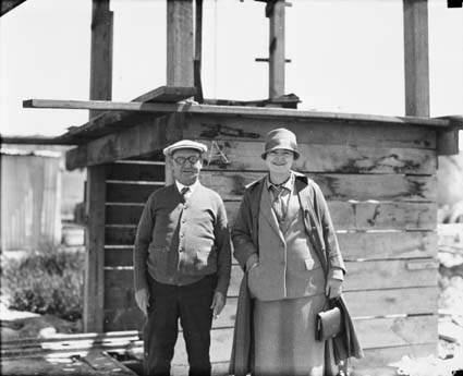 Man and woman near one the  sewerage excavation sites