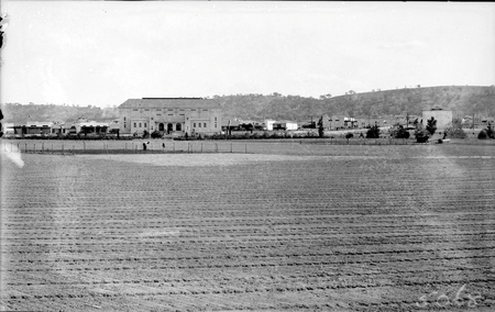  Manuka Oval being prepared for sowing. Capitol Theatre to the left. St Christophers school on the right. Red Hill at the rear