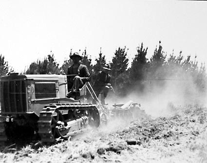 Crawler tractor towing tandem disc plough