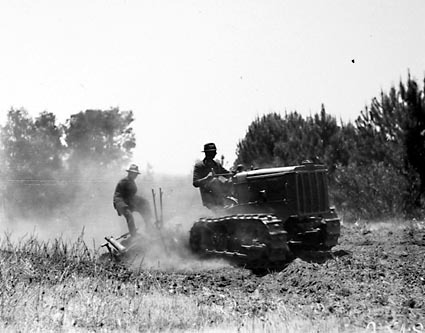 Crawler tractor towing tandem disc plough