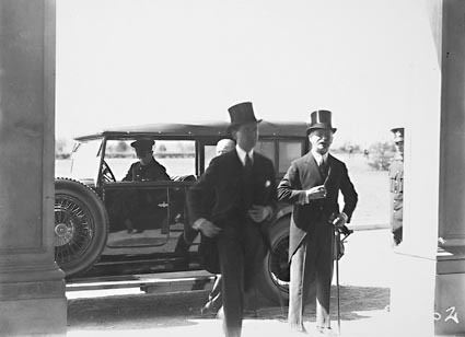Two men in top hats alighting from motor car (Lord Stonehaven on the right), under the porte cochere at Government House