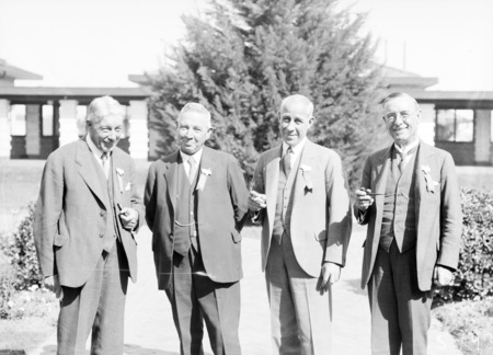 Second Conference of 65th District of Rotary delegates. Four executive committee members outside Hotel Canberra.