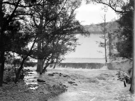 Cotter Dam Wall overflowing into the stilling pond and the Cotter River.
