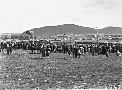 Anzac Day 1929 , Australian War Memorial site, Canberra - Spectators watching the March Past, Civic Centre in the background