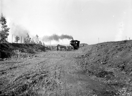 Steam shovel loading dray for road construction