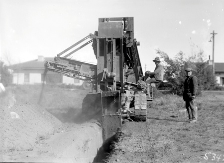 Ditch digger excavating a drainage trench