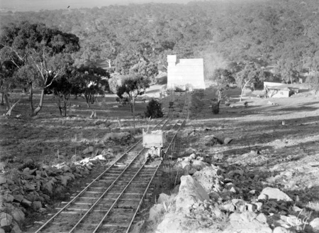 Stone crushing plant with tram lines and skip carrying rock to the crusher from Mugga Quarry.