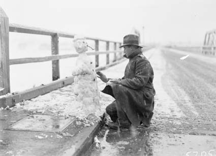 Record fall of snow - Man making a snowman on Billabong Bridge,  Commonwealth Avenue