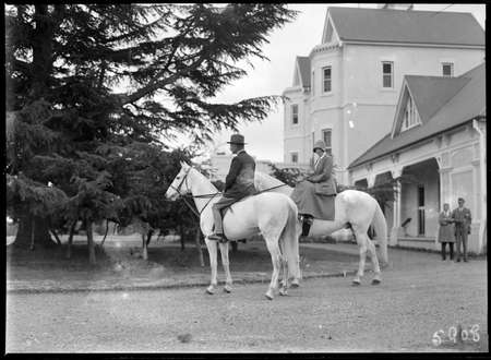 Lord Stonehaven and his wife on horseback (Lady Stonehaven is riding side saddle) at Government House, Yarralumla.