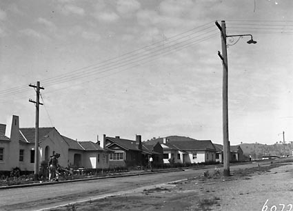 FCC cottages L to R type 3, Type 10, Type 7,Low voltage power lines and telephone lines in Arunta Street, Narrabundah