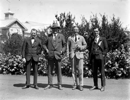 Group of four people including Mr H J H Honeyset, Canberra Community News