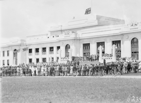 Armistice Day Ceremony with the Royal Military College Cadets on parade in front of Parliament House with spectators. View from Parkes Place.